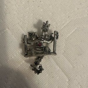 Pewter dragon on swing